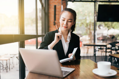 Young woman using laptop on table