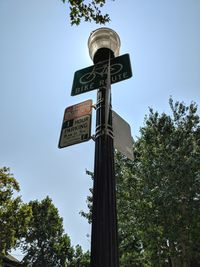 Low angle view of sign board against sky