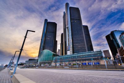 Low angle view of buildings against cloudy sky