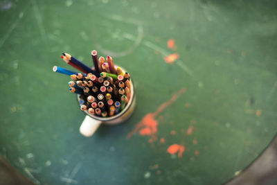 Close-up of colorful pencils in container on table