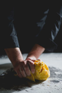 Close-up of chef's hands kneading dough