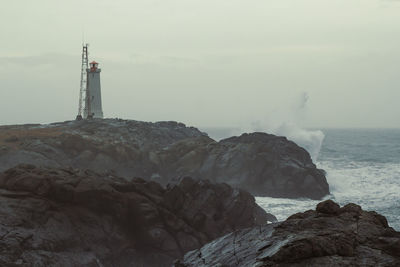 Beacon on rock over sea landscape photo