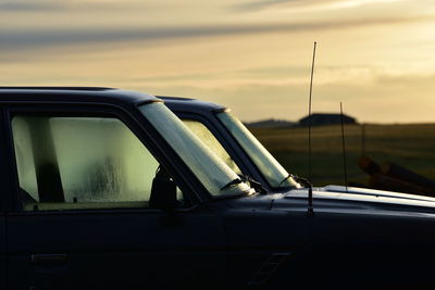 Reflection of sky on side-view mirror of car