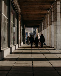 People walking on corridor of building