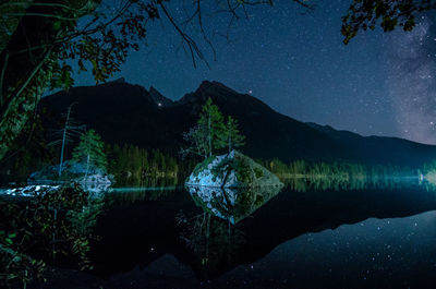 Scenic view of lake against sky at night