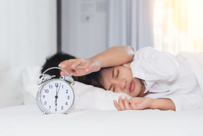 Boy sleeping on bed at home