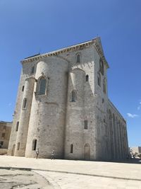 Low angle view of historical building against clear blue sky