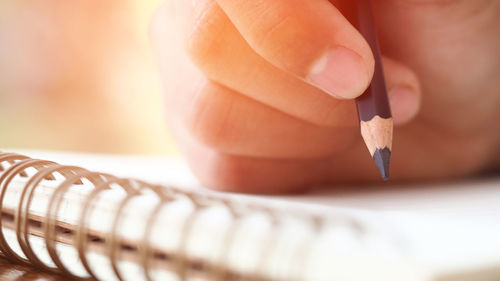 Close-up of hand holding pencils