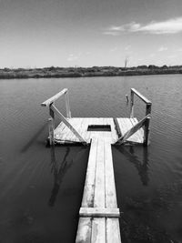 Pier on lake against sky