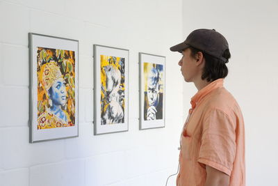 Man standing against wall in museum