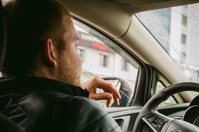 Close-up of man smoking in car