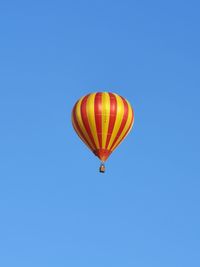 Low angle view of hot air balloon against blue sky