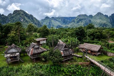 Scenic view of trees and houses against sky