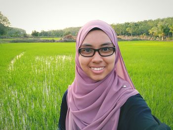 Portrait of smiling young woman in park