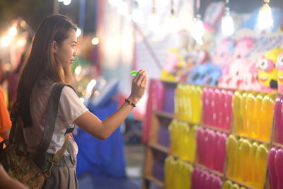 Side view of young woman holding dart