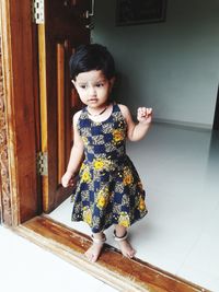 Portrait of cute girl standing on floor