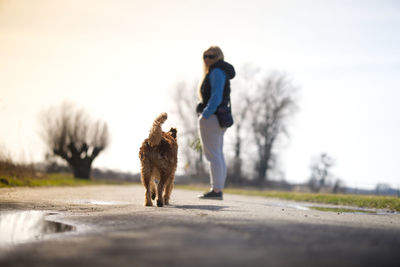 Side view of man walking on road