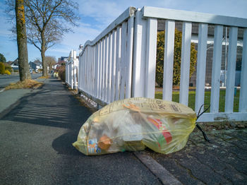 Yellow garbage bags are on the roadside and waiting for their pickup