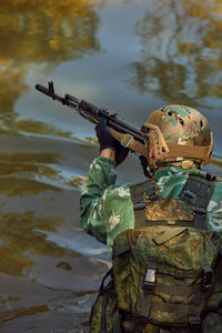 Rear view of man holding water