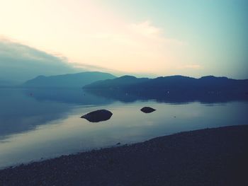 Scenic view of lake against sky during sunset