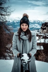 Portrait of woman standing in snow