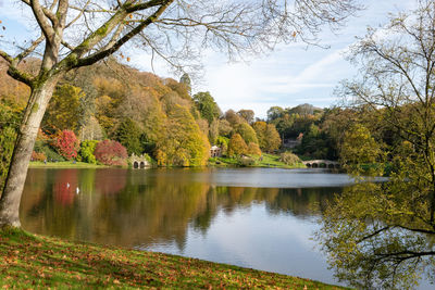 View of the autumn colours around the lake at stourhead gardens in wiltshire.