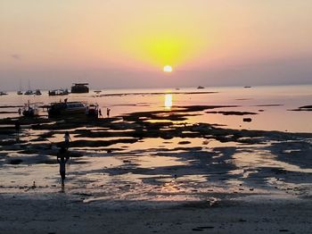 Scenic view of beach against sky during sunset