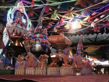 Illuminated lanterns hanging at market stall