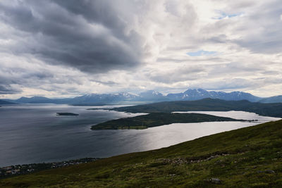 Scenic view of sea and mountains against sky