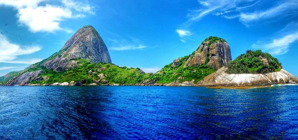 Scenic view of rocky mountains against cloudy sky