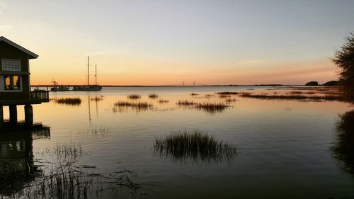 Scenic view of lake at sunset