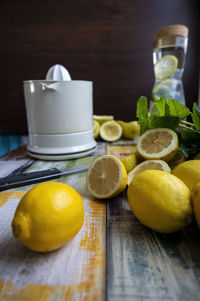 Preparation of fresh juices press on fresh lemon and lime. lemon squeezer machine or lemon presser.