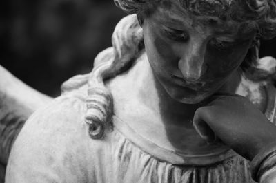 Close-up portrait of woman with sculpture