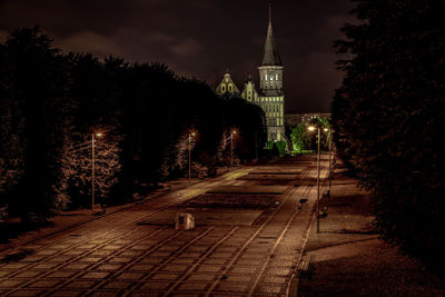 Illuminated city against sky at night