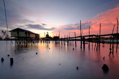 Scenic view of river against sky at sunset