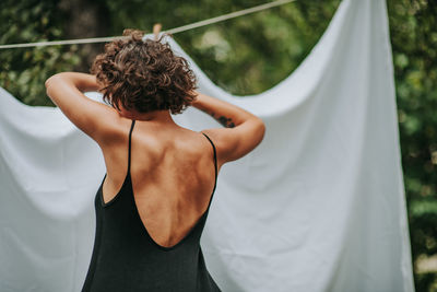 Rear view of woman standing outdoors