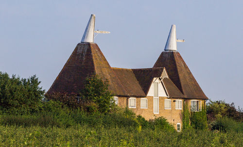 Building on field against clear sky