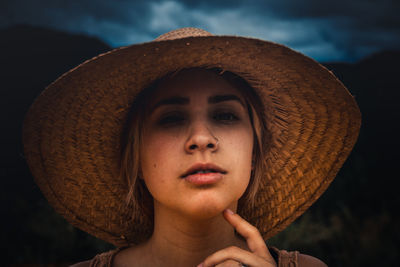 Close-up portrait of a young woman wearing hat