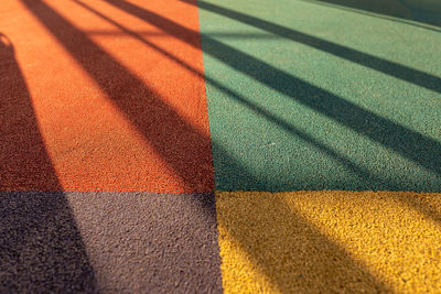 High angle view of multi colored shadow on tiled floor