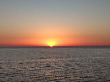 Scenic view of sea against orange sky