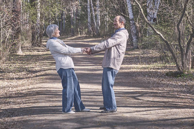 Rear view of two people standing outdoors