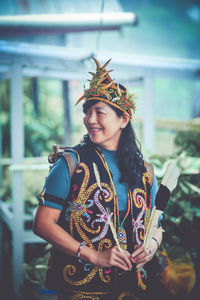 Portrait of young woman holding christmas tree