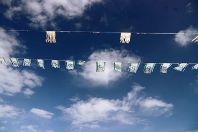 Low angle view of israeli flag hanging against blue sky