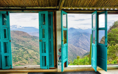 Scenic view of mountains seen through window