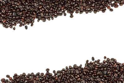 Close-up of coffee beans against white background