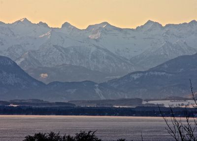 Calm lake against rocky mountains