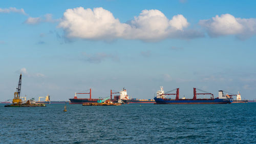 Commercial dock by sea against sky