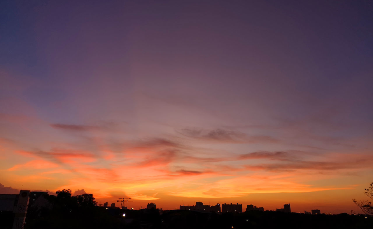 SILHOUETTE BUILDINGS AGAINST ORANGE SKY