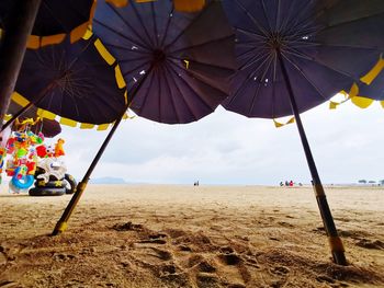 Umbrella on beach against sky