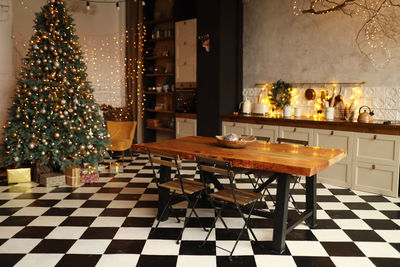 Christmas interior decorated kitchen and dining room in loft style